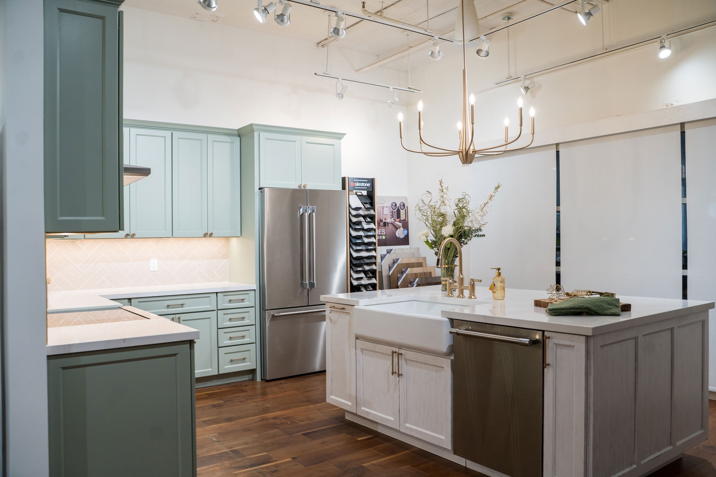 Pistachio painted kitchen cabinet display featuring Thermador french door refrigerator and dishwasher